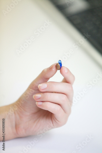Very small hearing aid in a female hand