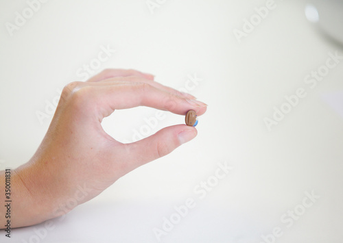 Very small hearing aid in a female hand