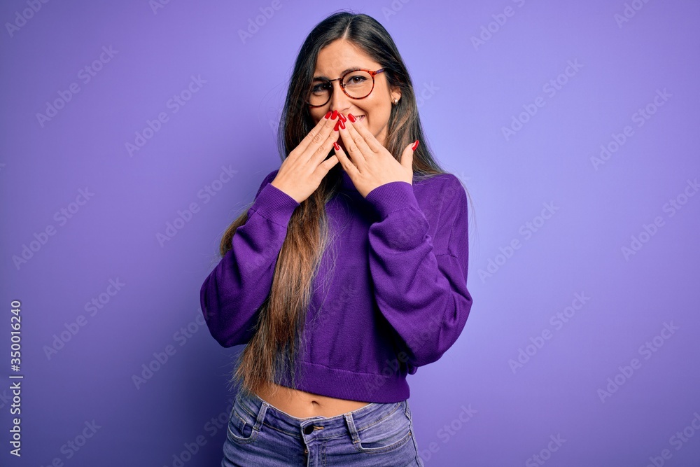 Young beautiful smart woman wearing glasses over purple isolated background laughing and embarrassed giggle covering mouth with hands, gossip and scandal concept Young beautiful smart woman wearing glasses over purple isolated background laughing and embarrassed giggle covering mouth with hands, gossip and scandal concept