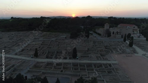 AERIAL DRONE SIDE VIEW AND FINAL ORBIT OF SUNSET IN ROMAN RUINES, EMPURIES, CATALONIA, SPAIN