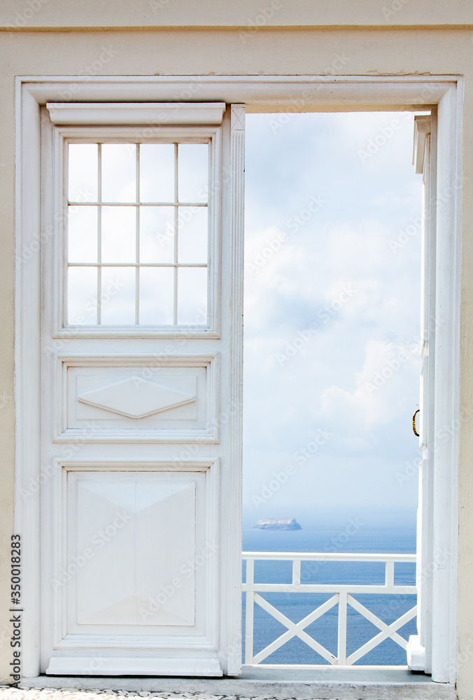 Fototapeta premium white door opening to blue sea