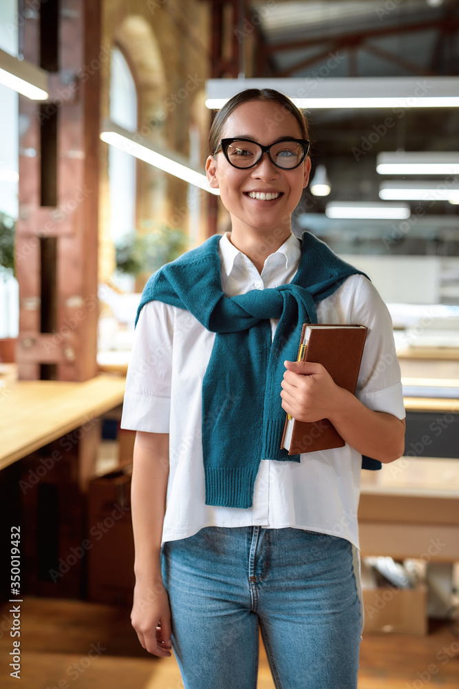 Fototapeta premium Great things for great works. Confident asian female office worker posing indoors