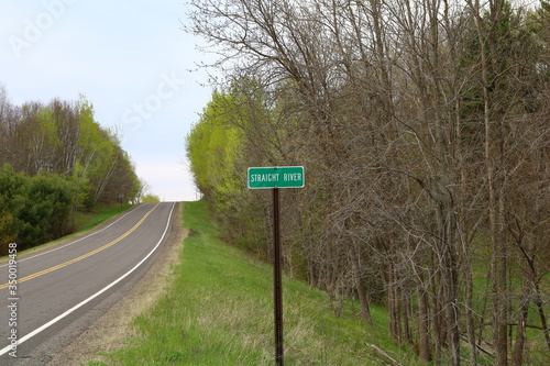 Road sign of the Straight River at the Tunnel Channel Woods near the Ice Age Trail in Polk County, WI during spring 