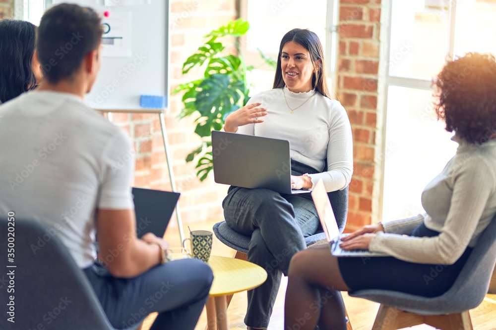 Group of business workers smiling happy and confident. Sitting on chairs relaxed with smile on face. Speaking taking rest at the office Group of business workers smiling happy and confident. Sitting on chairs relaxed with smile on face. Speaking taking rest at the office