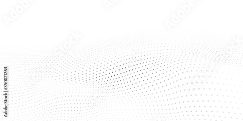 Abstract halftone background with wavy surface made of gray dots on white photo
