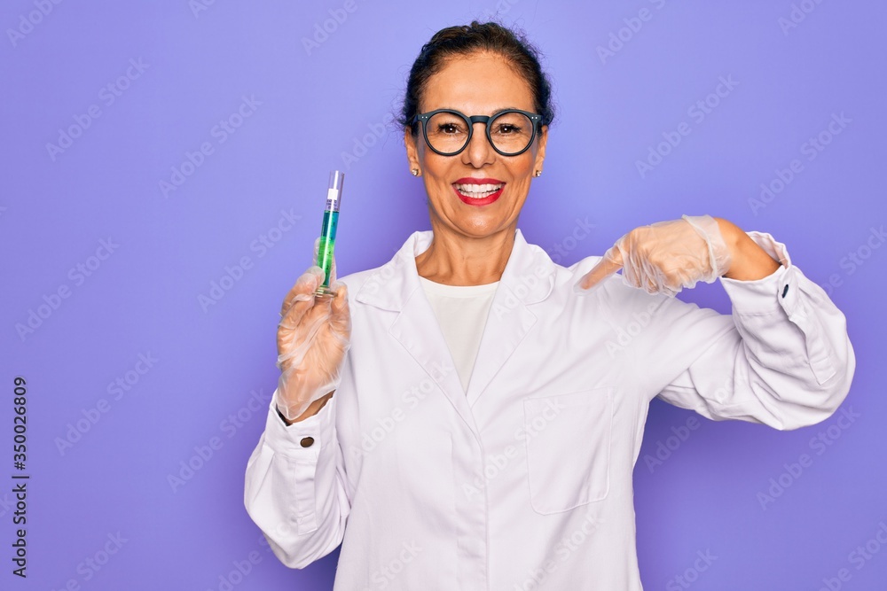 Middle age senior scientist woman wearing laboratory coat holding research test tube with surprise face pointing finger to himself Middle age senior scientist woman wearing laboratory coat holding research test tube with surprise face pointing finger to himself