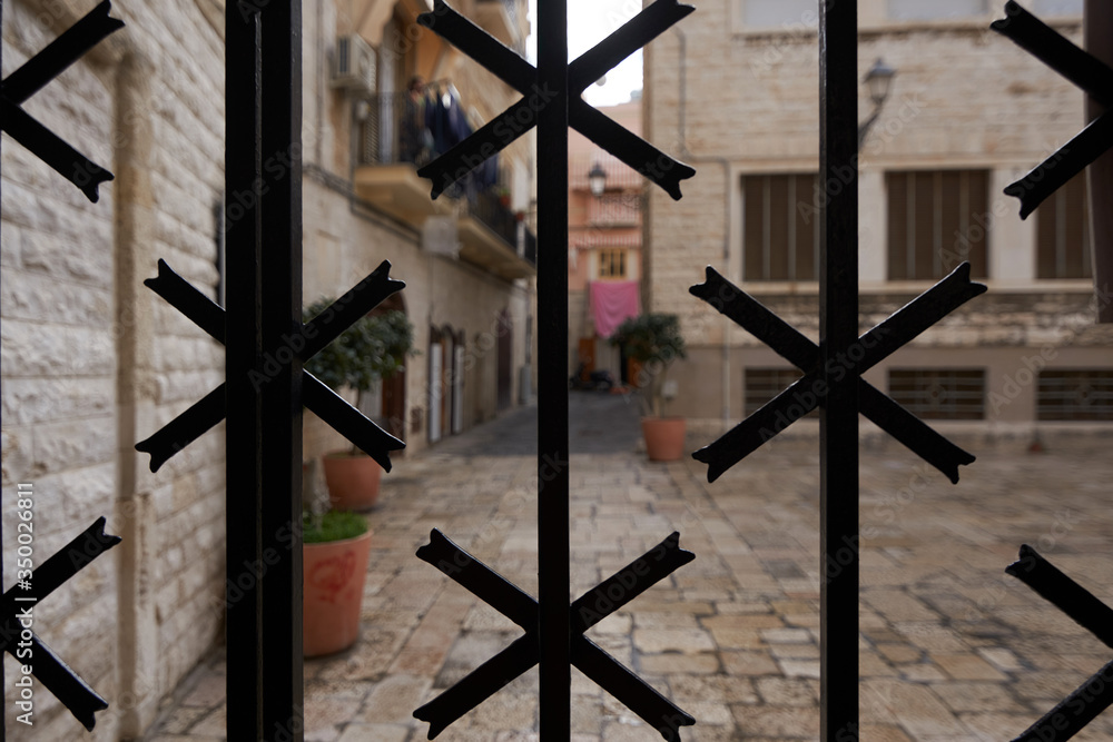 Ironwork With Typical Street Of southern Italy In The Background Ironwork With Typical Street Of southern Italy In The Background