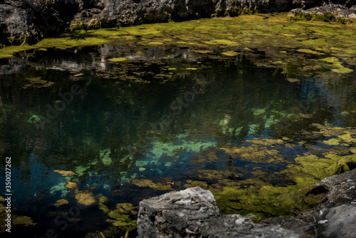 Blue water lagoon and rocks with moss