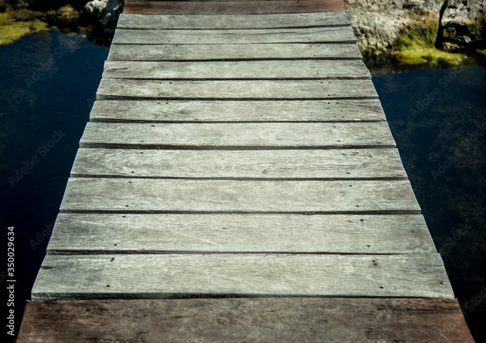 Wooden pier of a clear water lagoon Wooden pier of a clear water lagoon