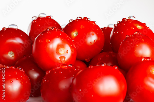 Wallpaper Mural Appetizing tomatoes with drops of water isolated on a white background. Copy space. Torontodigital.ca
