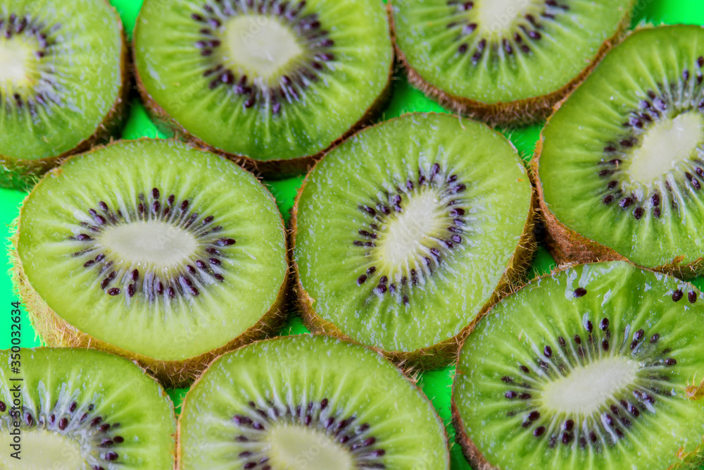 kiwi slices on a green background kiwi slices on a green background