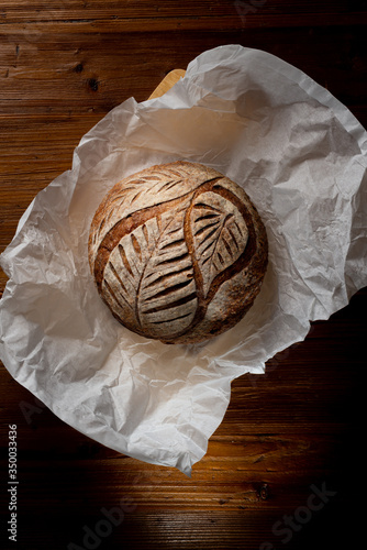 sourdough bread on delivery paper on wooden table