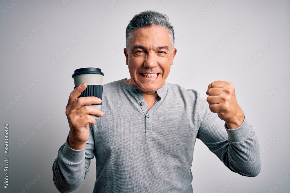 Middle age handsome grey-haired man drinking cup of coffee over isolated white background screaming proud and celebrating victory and success very excited, cheering emotion Middle age handsome grey-haired man drinking cup of coffee over isolated white background screaming proud and celebrating victory and success very excited, cheering emotion