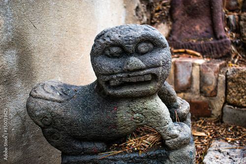 A miniature Komainu statue in Seoul. A Komainu is known as a lion dog who represents a gatekeeper against evil spirits.  photo