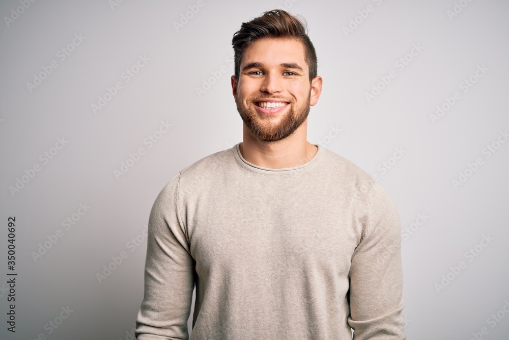 Young handsome blond man with beard and blue eyes wearing casual sweater with a happy and cool smile on face. Lucky person. Young handsome blond man with beard and blue eyes wearing casual sweater with a happy and cool smile on face. Lucky person.