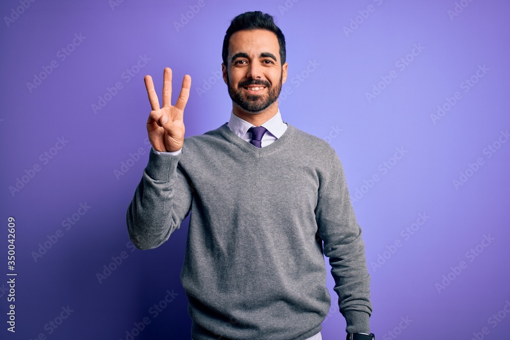 Handsome businessman with beard wearing casual tie standing over purple background showing and pointing up with fingers number three while smiling confident and happy. Handsome businessman with beard wearing casual tie standing over purple background showing and pointing up with fingers number three while smiling confident and happy.