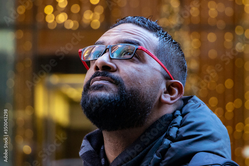 Man looking up with urban bright lit background 