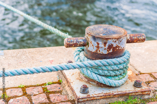Mooring rope wound around a mooring bollard on the embankment in Stockholm.Sweden