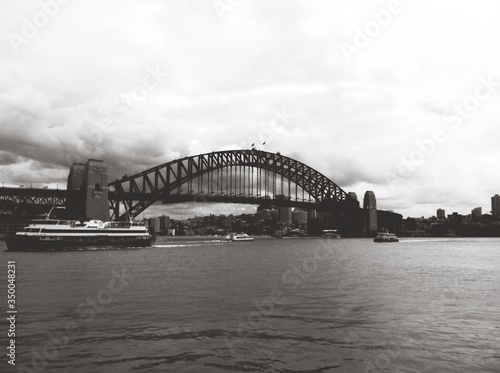 Low Angle View Of Sydney Harbor Bridge Over River Against Cloudy Sky #350048231