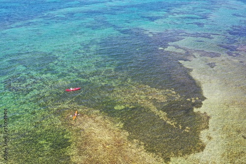 Key Biscayne  Florida - May 5  2020 - Young couple enjoys afternoon of kayaking on calm  clear water of Bear Cut on sunny May afternoon.
