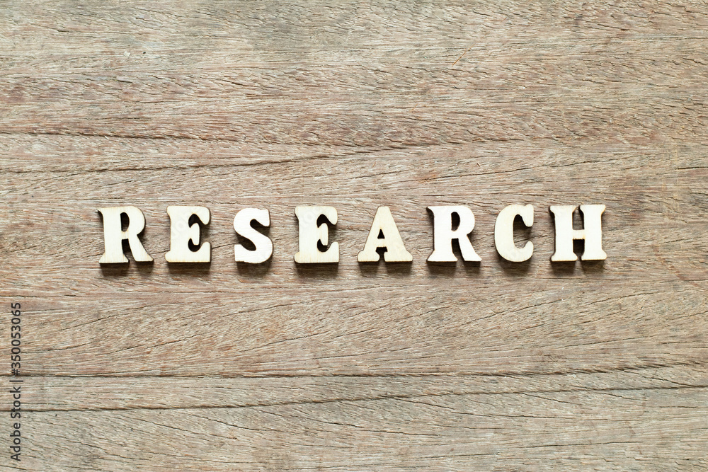 Letter block in word research on wood background Letter block in word research on wood background