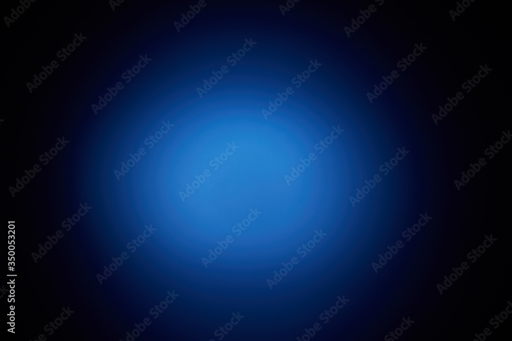 Blurred volumetric oval cloud of blue light against a dark background