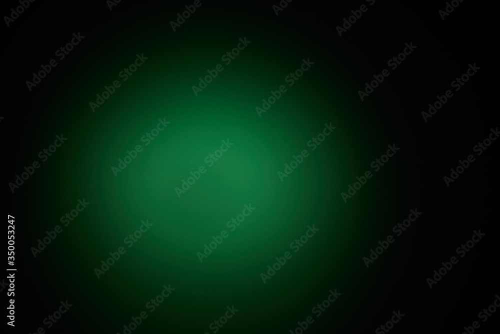 Blurred volumetric oval cloud of green light against a dark background