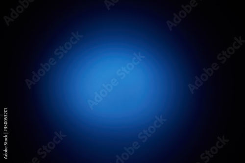 Blurred volumetric oval cloud of blue light against a dark background