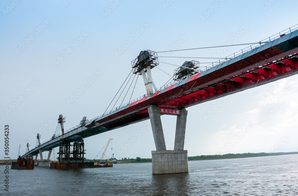 Fototapeta premium Russia, Blagoveshchensk, July 2019: Bridge on the Amur river from Blagoveshchensk to the Chinese city of Heihe in summer
