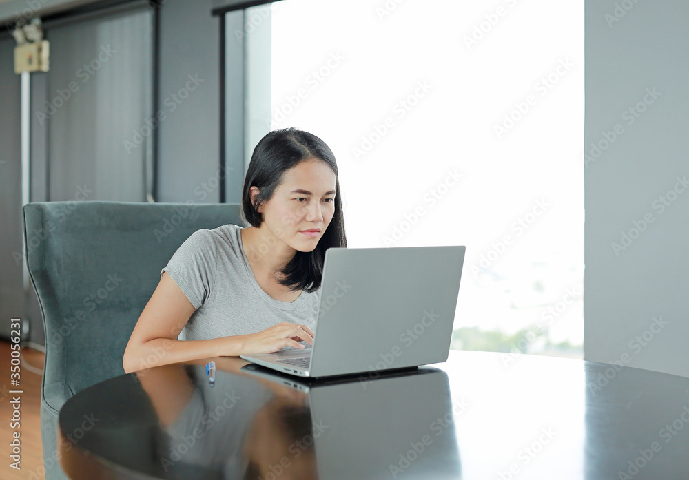 Beautiful asian woman using laptop computer working online at home. Beautiful asian woman using laptop computer working online at home.