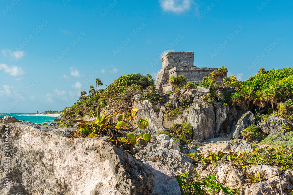 The Mayan Ruin of Tulum and its beach by the Caribbean Sea, Quintana Roo State, Yucatan Peninsula, Mexico. Foreground unsharp, sharp building.
