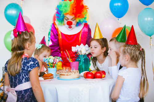 Children play with a clown