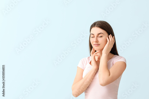 Young woman on color background