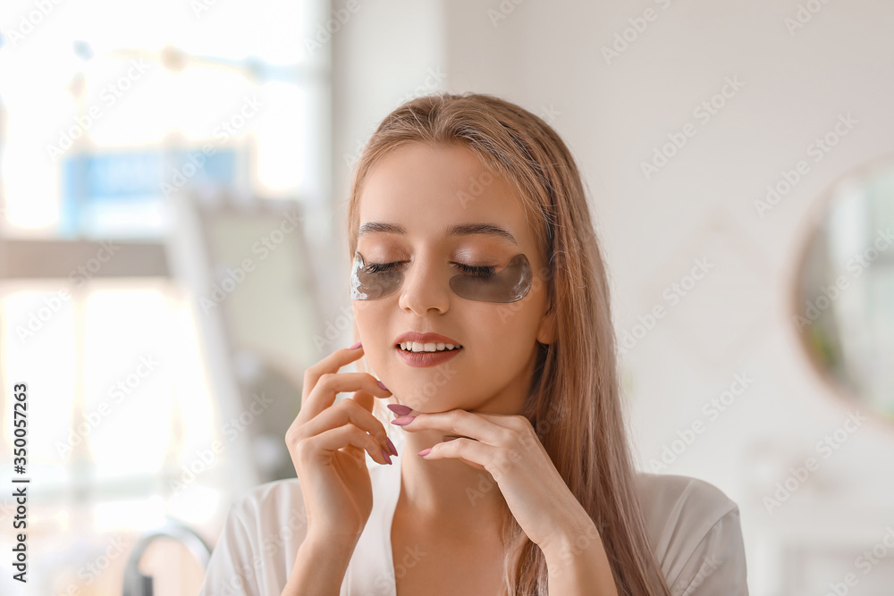 Beautiful young woman with under-eye patches in bathroom Beautiful young woman with under-eye patches in bathroom