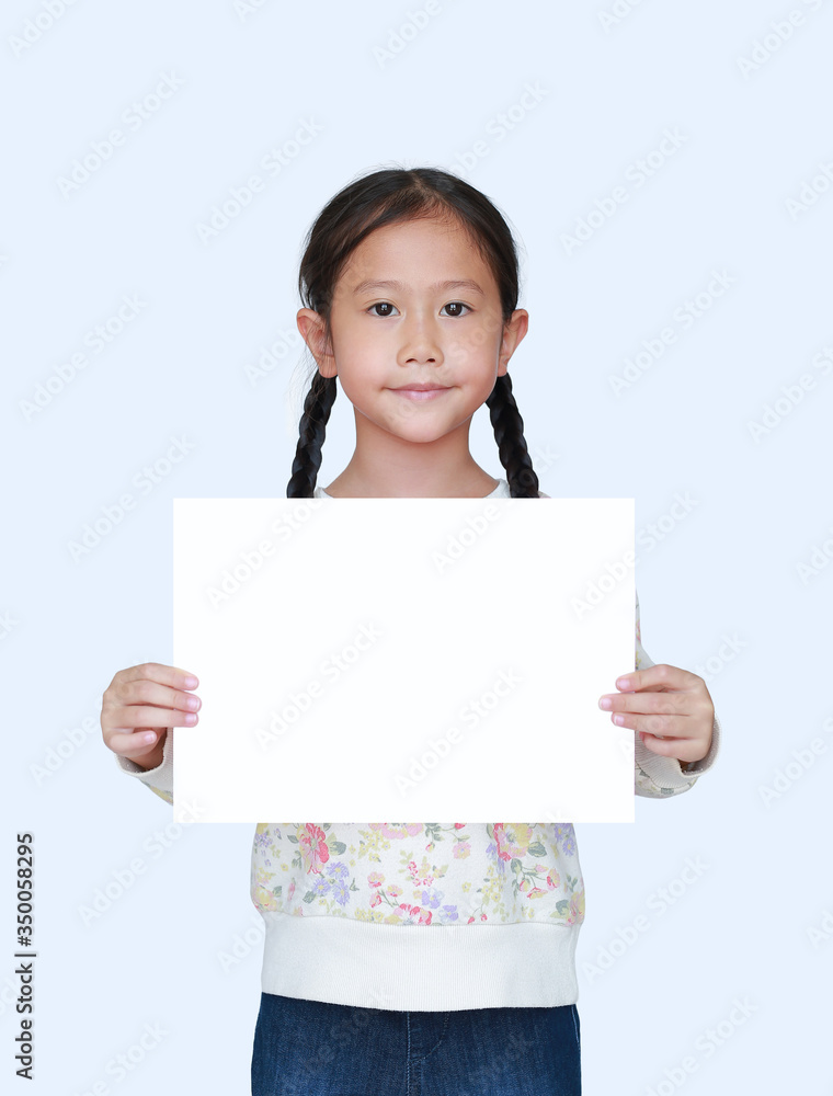 Little asian child girl showing blank white paper isolated on white background. Kid holding empty white square copy space Little asian child girl showing blank white paper isolated on white background. Kid holding empty white square copy space