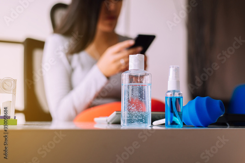 Sanitizer gel in spray bottle and hand sanitizer gel for coronavirus protection on table,Working at home,Work from home concept