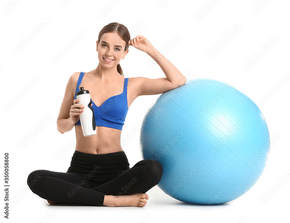 Sporty young woman with fitball and water on white background Sporty young woman with fitball and water on white background