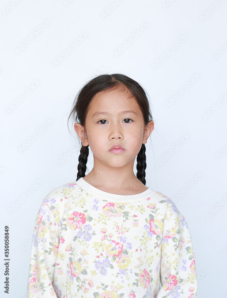 Peaceful asian little girl looking at camera over white background Peaceful asian little girl looking at camera over white background