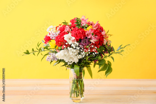 Wallpaper Mural Vase with bouquet of beautiful flowers on table against color background Torontodigital.ca