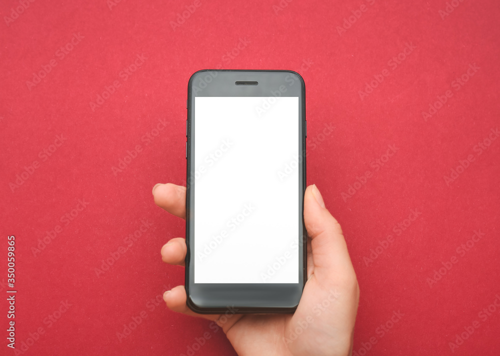 Female hand with mobile phone on color background Female hand with mobile phone on color background