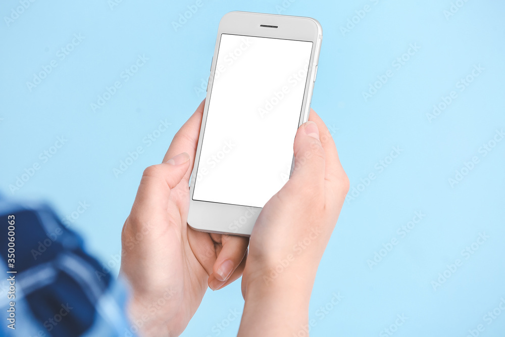 Woman with mobile phone on color background