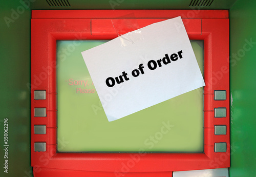 out of order text on white paper with stick on ATM.  Sorry ATM. out of service on screen photo