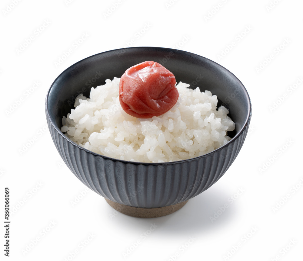 Japanese pickled plums and freshly cooked rice on a white background Japanese pickled plums and freshly cooked rice on a white background