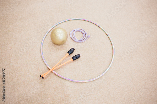 A variety of sports equipment: jump rope, Hoop, dumbbells on a white background. Top view of gym accessories