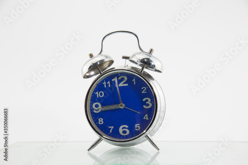 An alarm clock placed on a white background