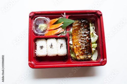 Japanese food put in a box placed on a white table