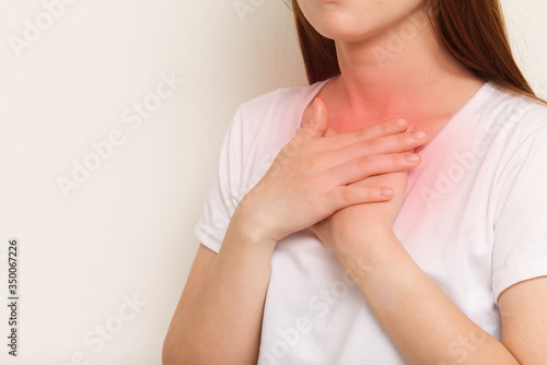 Young female suffering from severe chest pain. Health care conce