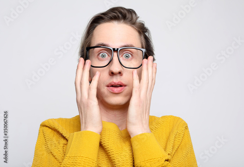 lifestyle, happiness, emotional and people concept: photo of stupefied handsome male has shocked expression, being surprised, isolated overwhite background. Astonished young crazy man feels stress. photo