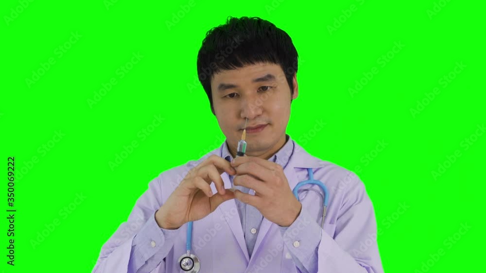 male doctor with coronavirus vaccine in syringe on green screen background male doctor with coronavirus vaccine in syringe on green screen background