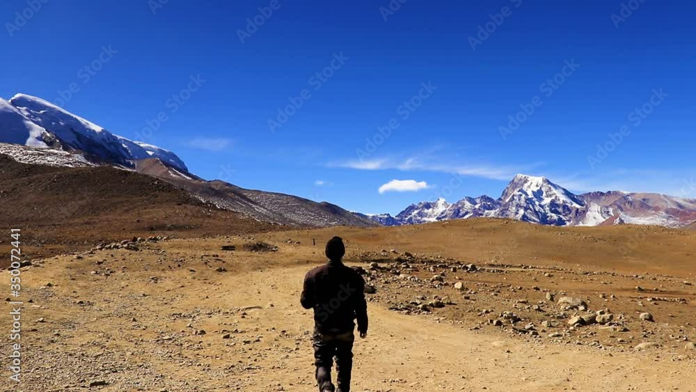 man walking at isolated off road surrounded with breathtaking himalayan mountains man walking at isolated off road surrounded with breathtaking himalayan mountains